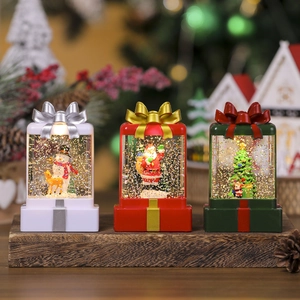 Three Christmas resin lanterns featuring Santa and snowman with glowing LED glitter water