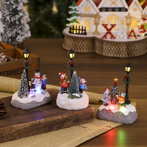 Light-up Christmas resin village set with snowman and tree on vintage paper base