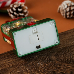 Detail of the bottom switch and battery compartment of the luminous Christmas lantern