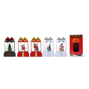 Christmas tree and Santa resin snow globes set in a red festive gift box