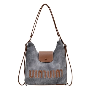 Gray washed canvas backpack tote for women with brown leather straps and vintage logo