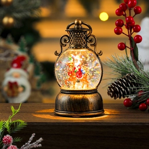 Close-up of vintage bronze Christmas snow globe lantern with Santa Claus and festive lights