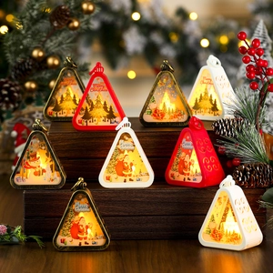 Close-up of vintage Christmas lanterns with Santa and reindeer motifs on wooden display
