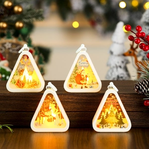 Set of four warm LED Christmas lanterns with festive Santa and snowman holiday prints