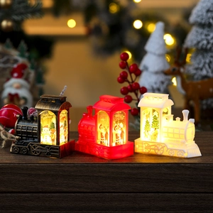 Set of three Christmas locomotive candle lanterns in bronze, red, and white colors