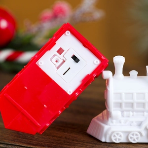 Detail of the battery compartment and ON/OFF switch on the red Christmas train lamp