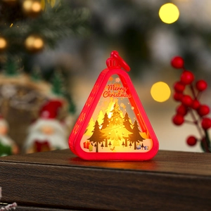 Detail of red Christmas lantern with Merry Christmas text and glowing LED on wood