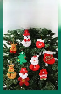 Close-up of plush Christmas ornaments featuring Santa and snowman on a festive tree