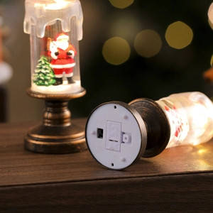 Detail view of a Christmas lantern with Santa miniature and battery compartment base