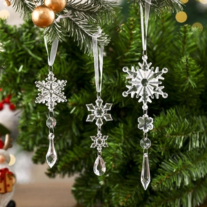 Close-up of clear acrylic snowflake pendants with teardrop beads on a Christmas tree