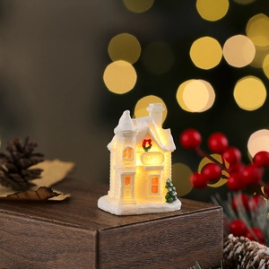 Macro view of a glowing resin Christmas toy shop house with warm LED lighting and snow texture