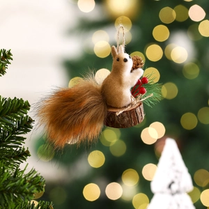 Detail of a squirrel Christmas ornament with fluffy tail on a wooden base with pine needles