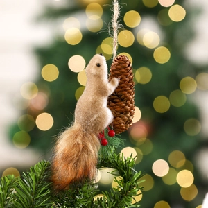 Close-up of a realistic squirrel ornament with pine cone and berries on a Christmas tree