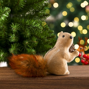 Detailed view of plush squirrel ornament with bushy tail holding a real pine cone