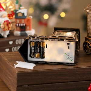 Detail of vintage Christmas train decor showing battery compartment and internal speaker