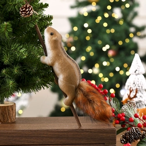 Detail of a fluffy faux fur squirrel ornament hanging on a glowing Christmas tree branch