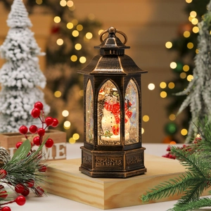 Close-up of vintage bronze Christmas lantern with swirling glitter and Santa snowman scene