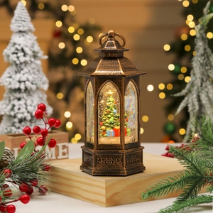 Macro view of vintage bronze lantern featuring a Christmas tree inside a glowing snow globe