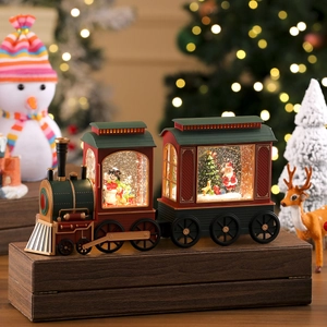 Detailed view of a vintage Christmas train music box with glowing scenes and Santa Claus