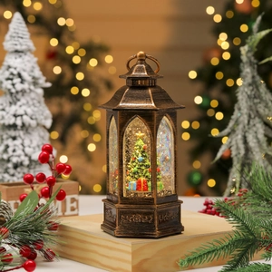 Macro shot of bronze Christmas lantern with a festive tree and swirling glitter snow