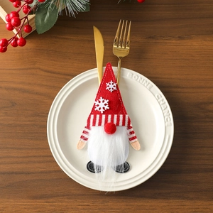 Close-up of a Christmas gnome cutlery holder with white snowflake embroidery on red felt
