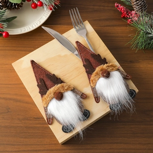 Gnome cutlery holder with reindeer antlers on a rustic Christmas table setting