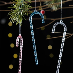 Set of 6 transparent acrylic candy cane ornaments hanging on a festive Christmas tree branch