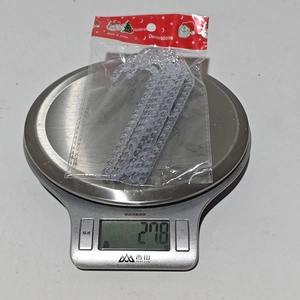 Detailed shot of 6pc acrylic Christmas candy cane ornaments weighed on a scale