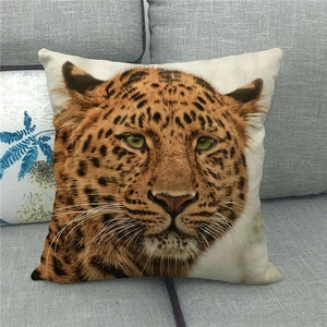 Linen decorative throw pillow cover featuring a realistic leopard head print on a gray sofa