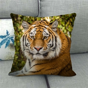 Detailed close-up of tiger print linen pillowcase on a grey textured sofa