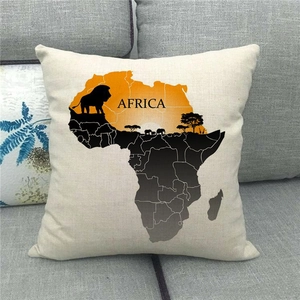 Close-up of linen cushion cover with Africa map and wildlife silhouette on gray sofa