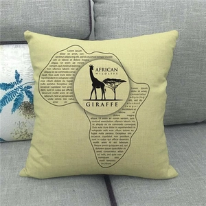 Detail of linen cushion cover showing giraffe silhouette and African wildlife pattern