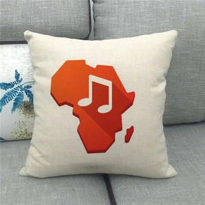 Close-up of linen pillow cover featuring orange Africa map with white musical note detail