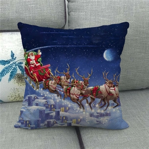 Detail of Christmas Santa sleigh linen pillowcase on a grey sofa with starry night print