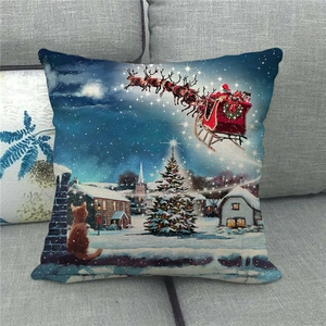 Detailed view of linen Christmas pillow cover with Santa and reindeer on a gray sofa