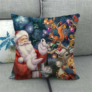 Detail of linen Christmas pillowcase with Santa and reindeer on a grey sofa