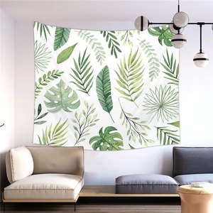 Detail of green monstera leaves printed on a peach skin wall tapestry in a modern living room