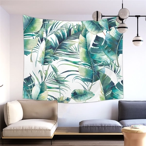 Detailed view of a tropical green palm leaf tapestry hanging in a modern living room