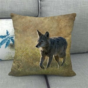 Linen pillowcase detail showing a realistic wolf wildlife print on a grey sofa