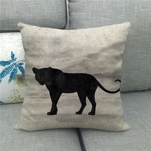 Close-up of textured linen pillowcase featuring a black panther illustration on a sofa