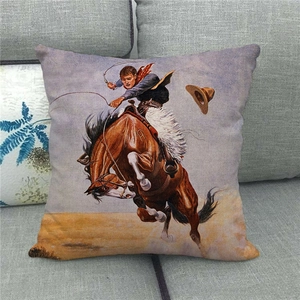 Detail of linen pillowcase featuring a vintage cowboy riding a horse on a grey sofa