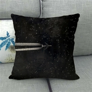 Detail of soft fabric texture on square decorative pillow with starry sky and plane print