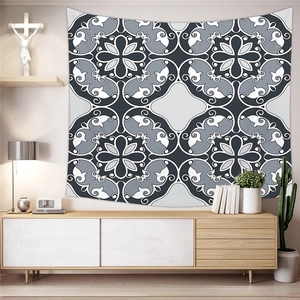 Detail of bohemian mandala tapestry in black and white on a minimalist living room wall