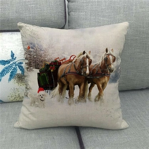 Detailed texture of linen Christmas pillowcase with horses and sled on a sofa