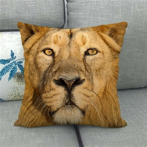 Detailed realistic lion face print on square linen pillowcase on a grey fabric sofa