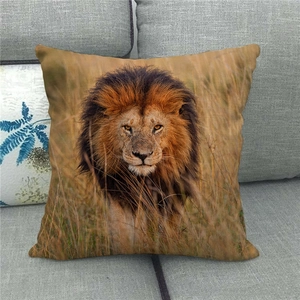 Detail of square linen pillowcase featuring a realistic wildlife lion print on a grey sofa