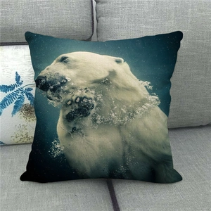 Detail of linen throw pillow featuring a realistic polar bear underwater photography print