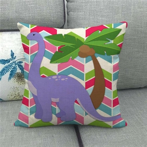 Detail of linen cushion cover featuring cartoon dinosaur applique and geometric stripes