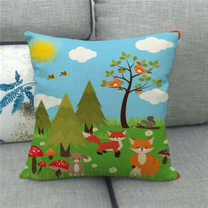 Detail of linen pillowcase featuring a cute forest fox and rabbit cartoon print on a sofa