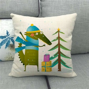 Detail of square linen pillowcase with cute cartoon crocodile and Christmas tree pattern